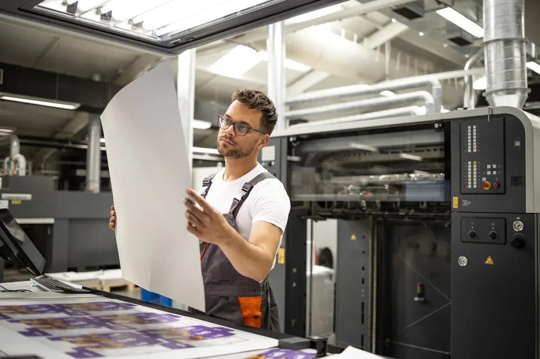 Print Shop Worker Checking Quality - Imprint Controlling Printing Process